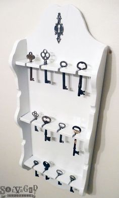 a white shelf filled with lots of keys