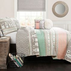 a bed room with a neatly made bed next to a window and a basket on the floor