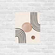 a white brick wall with a black and beige abstract painting on it's side