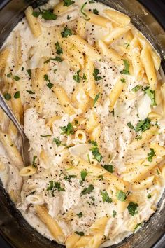 a bowl filled with pasta covered in sauce and garnished with parmesan