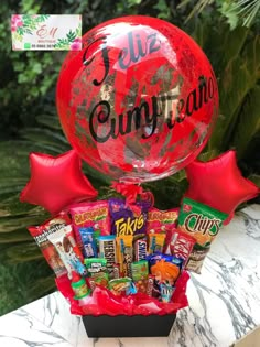 a red balloon filled with candy and balloons