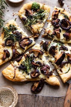 a pizza with mushrooms and herbs on it