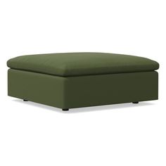 a green ottoman that is sitting on the ground