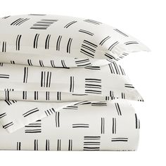 three pillows stacked on top of each other in front of a white background with black lines