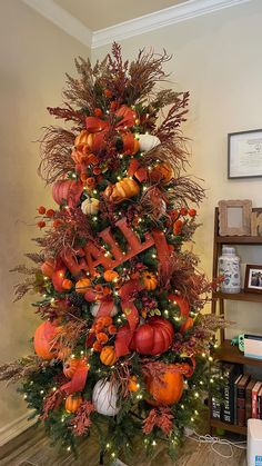 a decorated christmas tree with pumpkins and other decorations