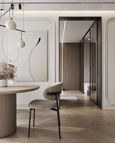 an elegant dining room with white walls and wood flooring is featured in this image