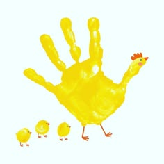 a handprint with an image of a yellow chicken and her chicks on white background