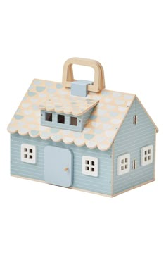 a wooden toy house with a blue roof