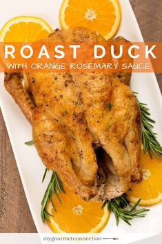 roast duck with orange rosemary sauce on a white platter surrounded by sliced oranges