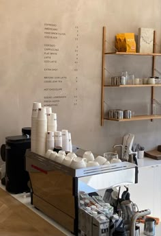 there is a coffee shop with many cups on the counter