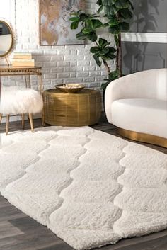 a living room with white furniture and rugs