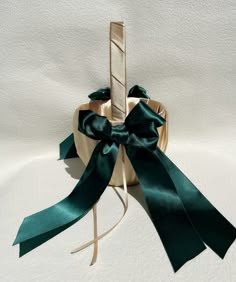 a green ribbon tied around a wooden stick with a bow on it's end