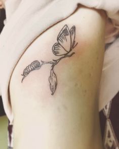 a woman with a tattoo on her stomach has a flower in the shape of a leaf