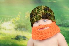 a baby wearing a crocheted hat and beard with an orange beard on it's head