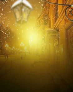 an image of a street light in the middle of town at night with snow falling all around