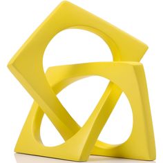 a yellow sculpture sitting on top of a white floor