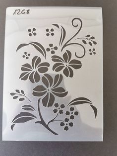 an image of a flower stencil on a glass block with the word kcq