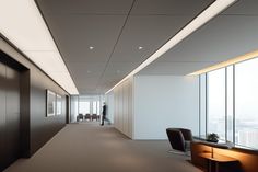 an empty office hallway with chairs and desks