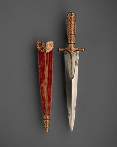 two decorative swords are on display against a gray background, one is red and the other is gold