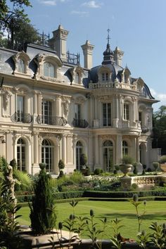 a large building with many windows and balconies on the top floor, surrounded by greenery