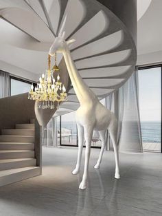 a giraffe standing next to a staircase with chandelier