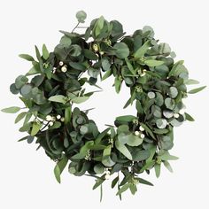 a wreath with green leaves and white berries