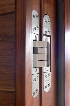 a close up of a wooden door with two metal latches on the front and back doors