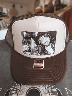 Ride in style with the iconic Waylon and Willie Trucker Hat. This unique hat features the legendary country music duo and adds a touch of personality to any outfit. Perfect for classic music lovers! Please Note* Most orders ship out within 3 business days. Occasionally it can take up to 14 days to ship depending on inventory Waylon And Willie, Retro Adjustable Baseball Cap For Rodeo, Adjustable Retro Baseball Cap For Rodeo, Retro Brown Adjustable Snapback Hat, Adjustable Vintage Snapback Hat For Rodeo, Vintage Adjustable Baseball Cap For Rodeo, Vintage Snapback Hat For Rodeo, Adjustable 5-panel Hat For Rodeo, Adjustable 5-panel Rodeo Hat