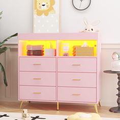 a baby's room with a pink dresser and yellow lights on the top shelf