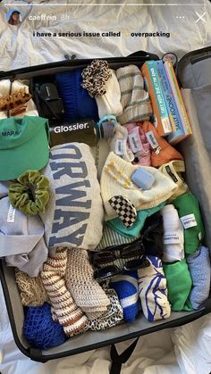 an open suitcase filled with clothing and accessories