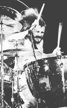 black and white photograph of drummer playing drums