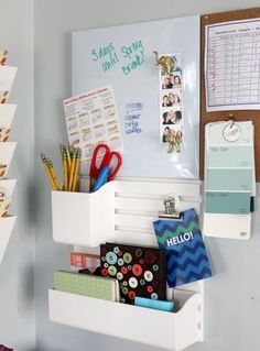 a white wall mounted shelf filled with office supplies