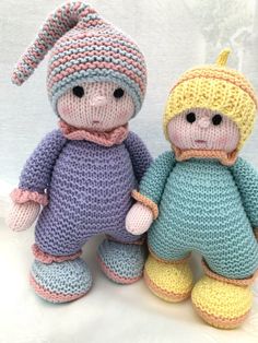 two crocheted dolls sitting next to each other