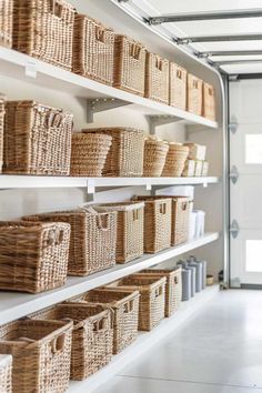 baskets are lined up on shelves in a storage area at the end of a hallway