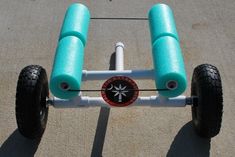 a blue and white tricycle with two wheels on the front, sitting on concrete