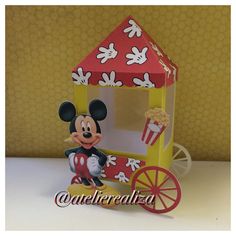 a paper model of mickey mouse on a cart with popcorn in the front and cupcakes in the back