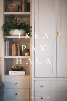 an open bookcase with books and plants on it, next to a white cabinet