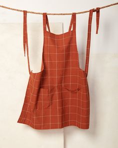 an orange apron hanging on a clothes line