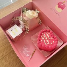 a pink birthday cake in a pink box