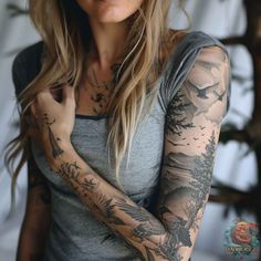 a woman with tattoos on her arms and arm