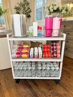 a white cart with drinks and snacks on it