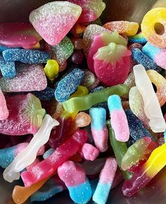 there are many different colored candies in the bowl