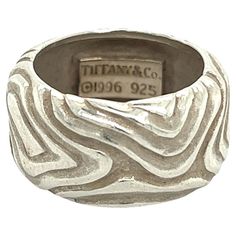 Authentic Tiffany & Co Estate Woodgrain Design Ring 4.5 Silver 11 mm 5.7 Grams TIF630 TRUSTED SELLER SINCE 2002 DETAIL Design: Woodgrain Ring Size: 4.5 Height: 11 mm Weight: 5.7 Grams Metal: Sterling Silver We try to present our estate items as best as possible and most have been newly polished some of the Tiffany items may have a natural patina As they are estate silver pieces. Please refer to the pictures as they are the actual items you will receive. Please see the pictures as this is the exact item that you will receive. Some of our Tiffany & Co items have the natural patina as they are estate silver pieces and many clients wish to purchase the items as is and have requested that they not be polished. Some of the listed Tiffany & Co items do come with their original box and packaging. Mens Tiffany Rings, Tiffany Co Rings, Louis Comfort Tiffany, Detail Design, Japan Design, Tiffany And Co, Silver Pieces, Tiffany & Co., Ring Verlobung