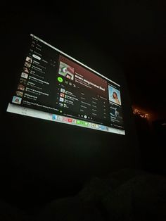 a large screen is lit up in the dark