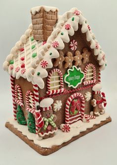 a gingerbread house decorated with candy canes and cookies