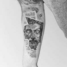 a man's arm with some tattoos on it