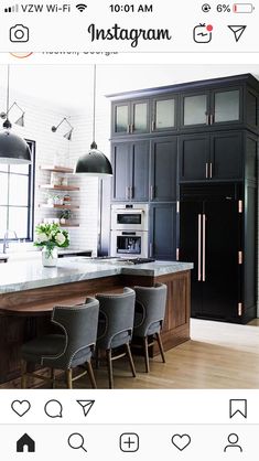 an instagram page with black cabinets and grey chairs