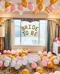 balloons and streamers in the shape of letters are on display at a bridal to be party