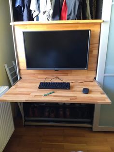 a computer monitor sitting on top of a wooden desk