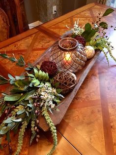 a wooden table topped with candles and flowers